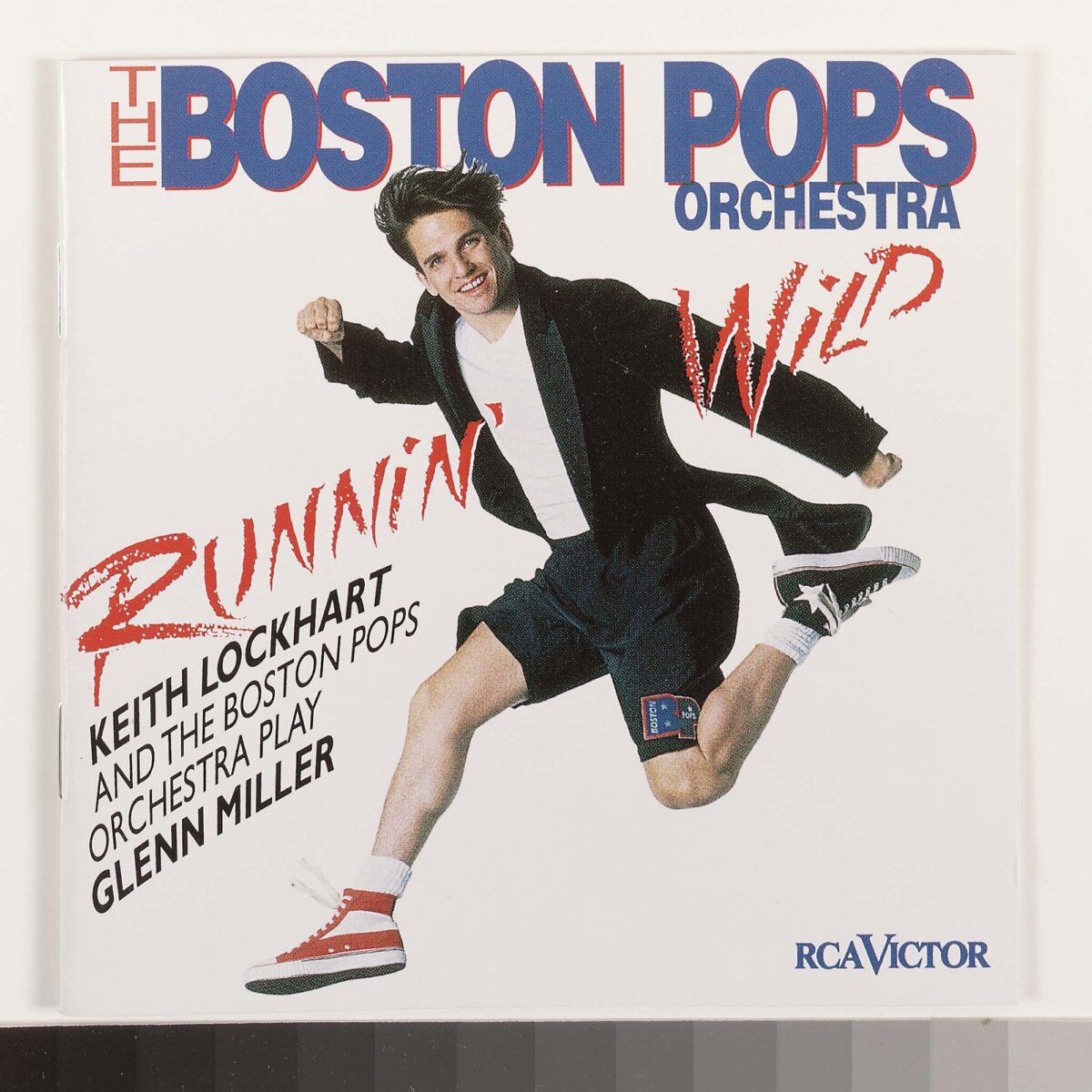 On the cover of Runnin' Wild, Keith is smiling and running in red and black sneakers, wearing shorts and a t-shirt under a black tailcoat.