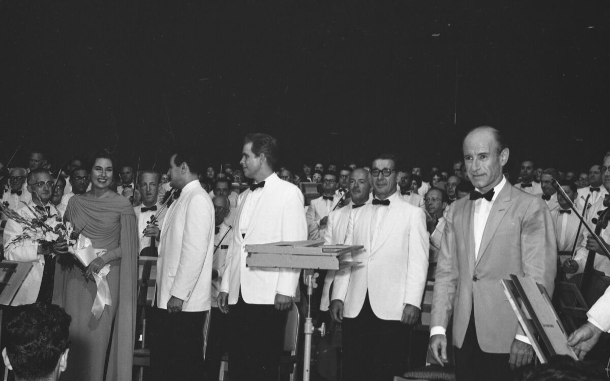 Performers stand on stage after a performance