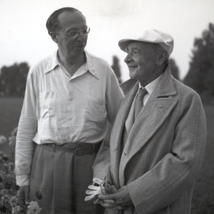 Aaron Copland and Serge Koussevitzky stand together outdoors