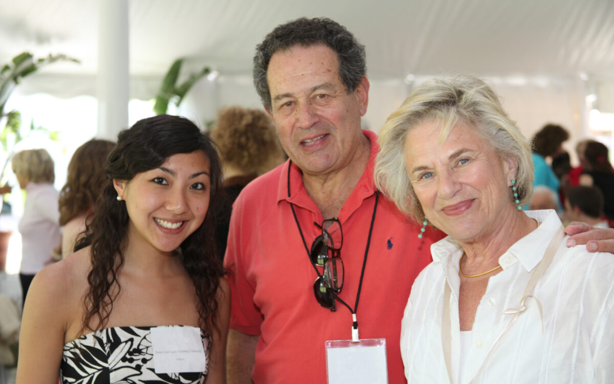 A TMC Fellow and two donors at an event