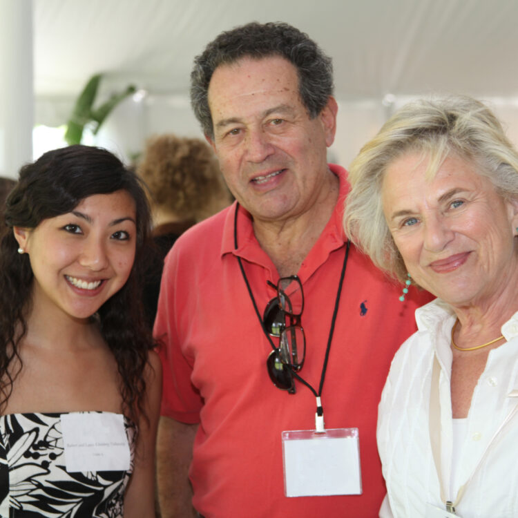 A TMC Fellow and two donors at an event