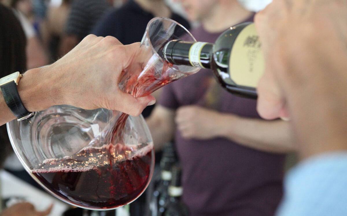 Close up of red wine being poured from a bottle into a glass
