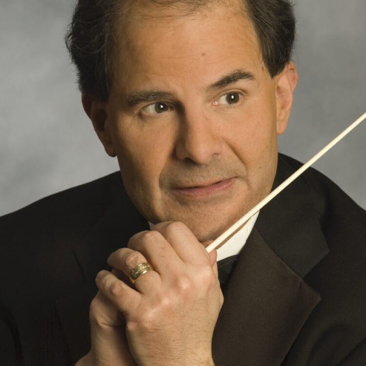 Headshot of David Martins wearing a tuxedo and holding his baton