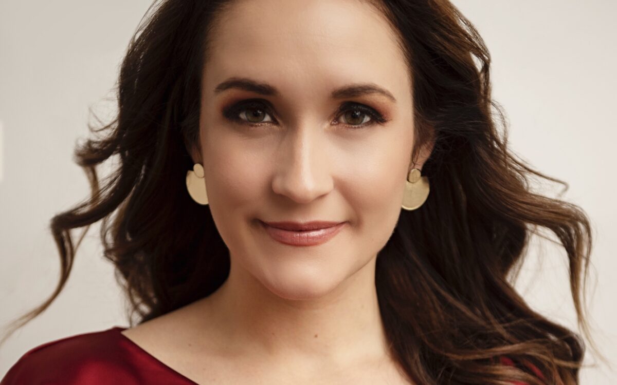 Erin Morley wearing a red dress, smiling