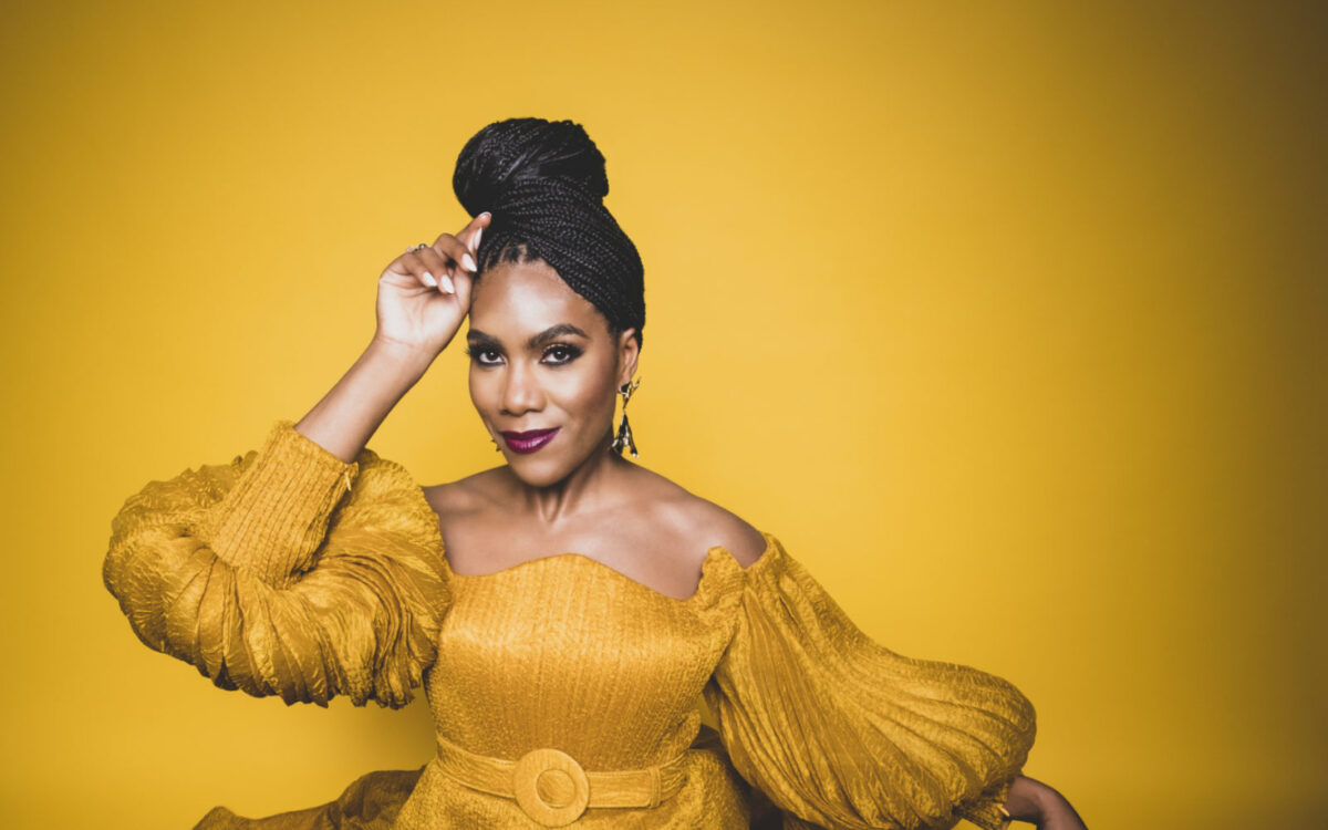 J'Nai Bridges wearing a marigold colored gown