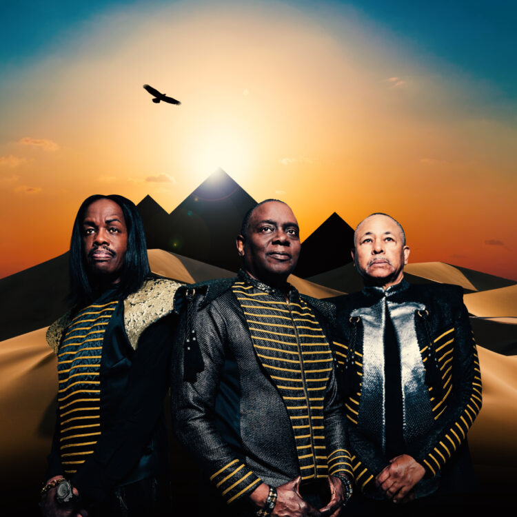 Earth, Wind & Fire pose in front of a pyramid backdrop