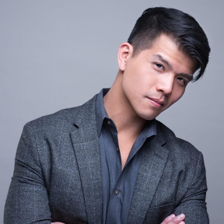Headshot of Telly Leung wearing a grey suit