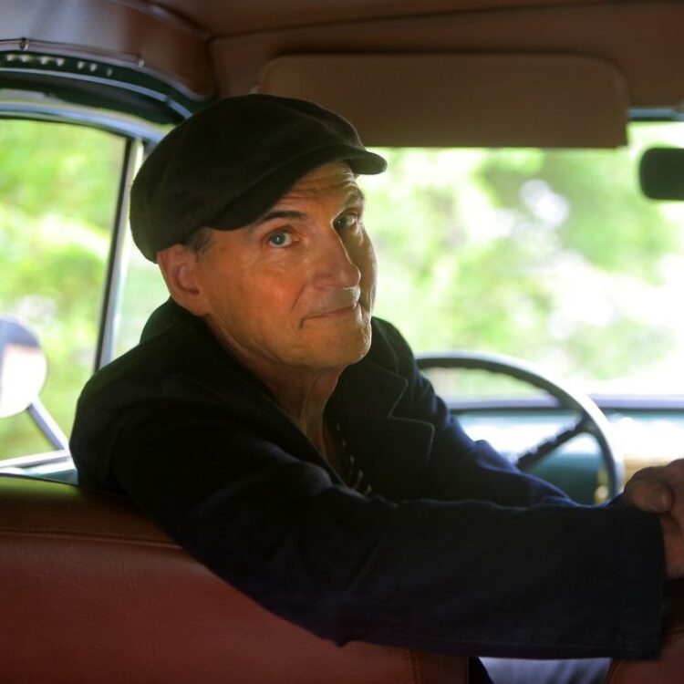 Portrait of James Taylor sitting in a car.