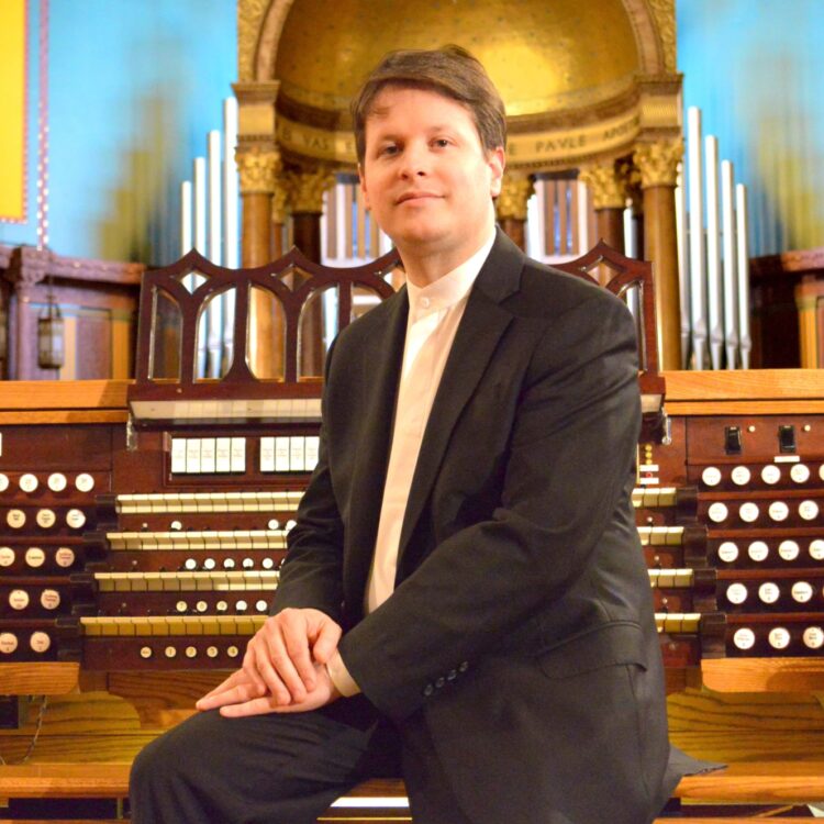 Paul Jacobs sitting in front of an organ