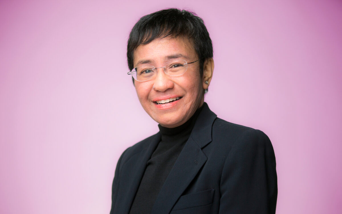 Maria Ressa in front of a pink background