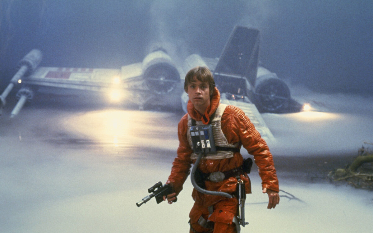 Luke Skywalker leaves his X wing, with a blaster in his hand