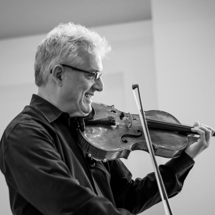 Black and white picture of Ed Gazouleas playing the viola