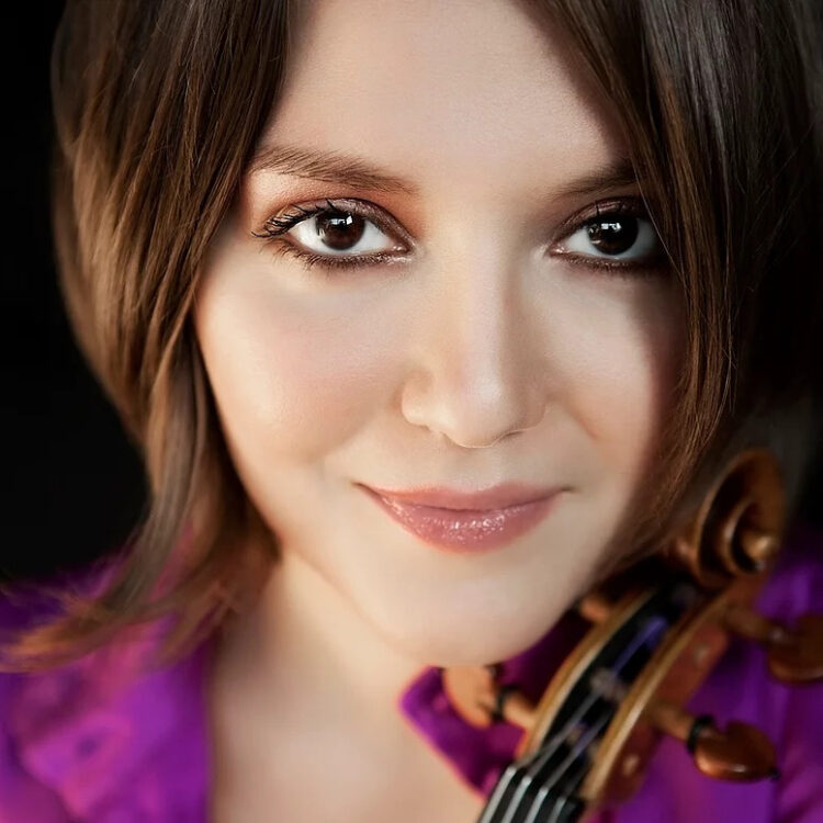 Areta Zhulla headshot with the scroll of her violin