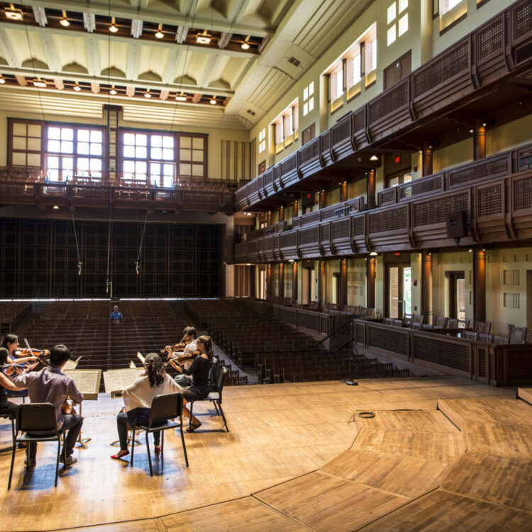 six musicians sitting in a circle playing on the Ozawa Hall Stage