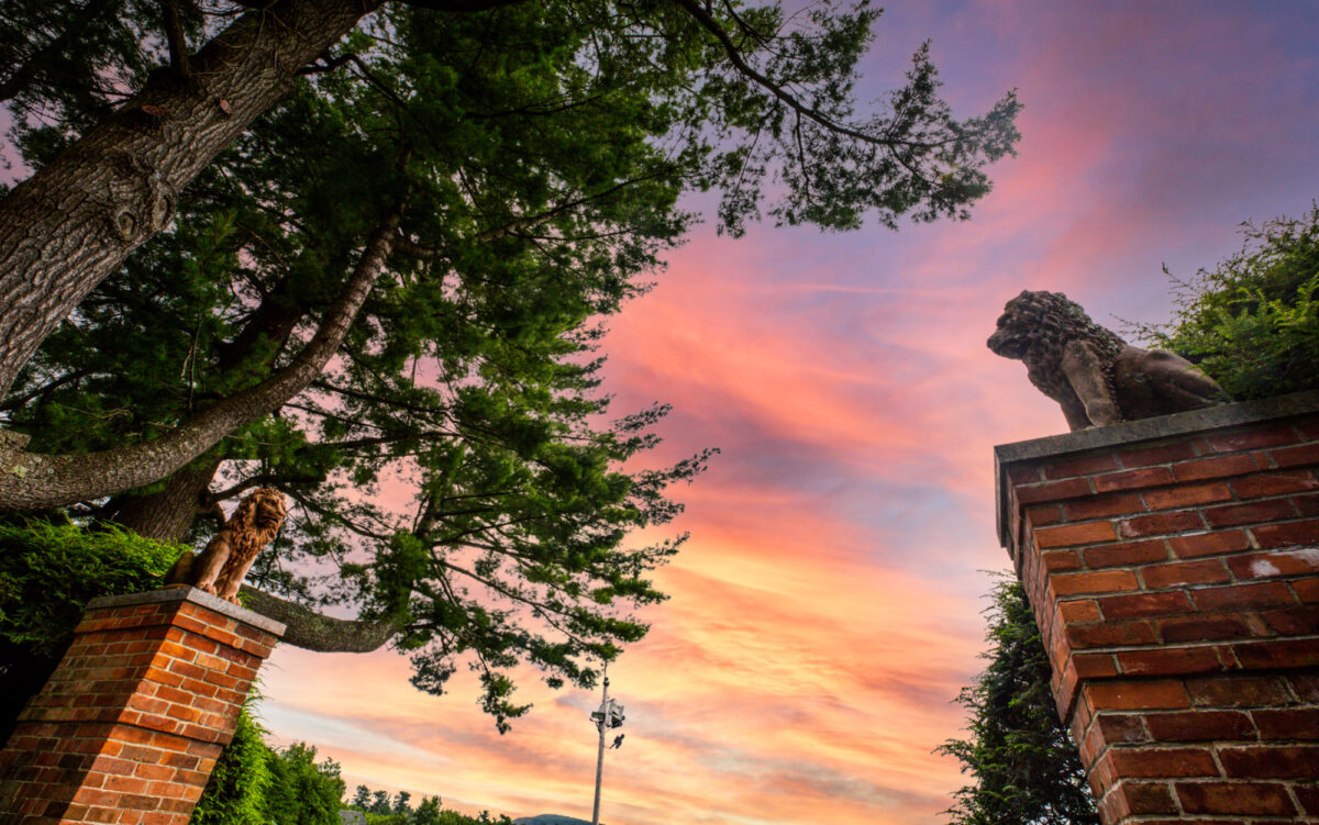 Sunset between columns with lion statues at top