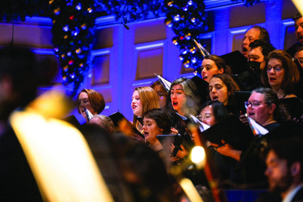 a chorus sings on festively decorated stage