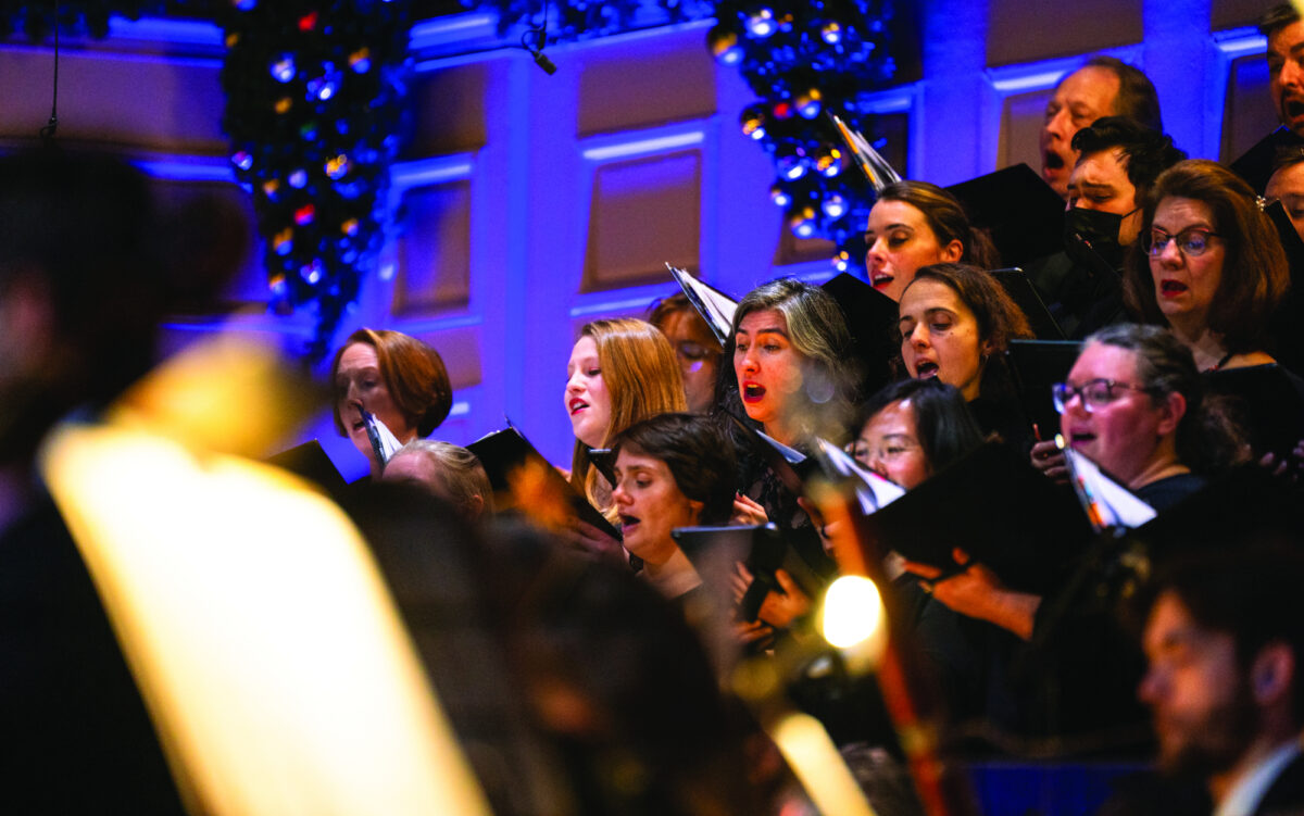 a chorus sings on festively decorated stage