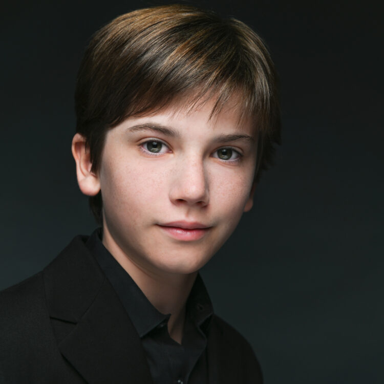 Headshot of Linus Schafer-Goulthorpe wearing a black collared shirt.